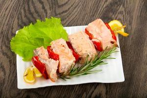 Salmon Skewer on the plate and wooden background photo