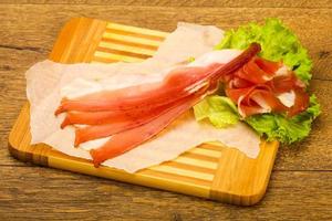 Hamon on wooden board and wooden background photo