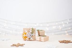 Eco friendly packaging gifts in craft paper on wooden table. Zero waste Christmas holiday concept. Close up, copy space photo