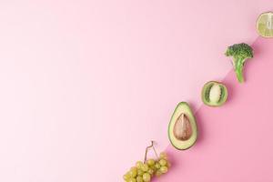 Fresh fruits and vegetables on pink background. Healthy eating concept. Flat lay, copy space. photo