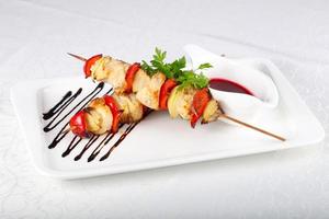 Chicken skewer on the plate and white background photo