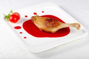 Duck leg on the plate and white background photo
