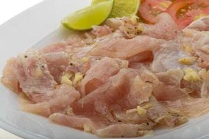 Swordfish carpaccio on white photo