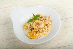 Muesli on the plate and wooden background photo