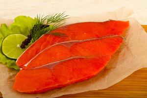 Salted salmon on wooden board and wooden background photo