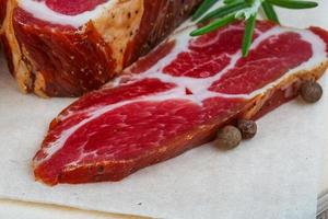 Chuck steak on wooden board close up view photo