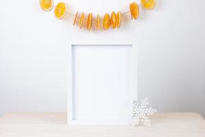 Zero waste Christmas natural decoration with white mock up frame on table. Close up, copy space photo