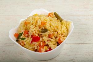 Mexican rice in a bowl on wooden background photo