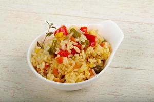 Mexican rice in a bowl on wooden background photo