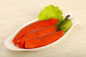 Salted salmon in a bowl on wooden background photo