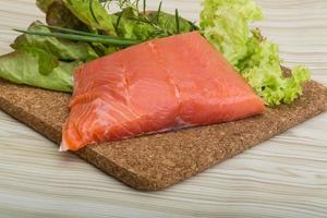 Salmon fillet on wood photo