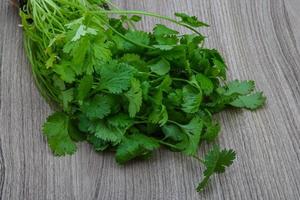 Coriander leaves on wooden background photo