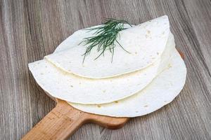 tortillas en tablero de madera y fondo de madera foto