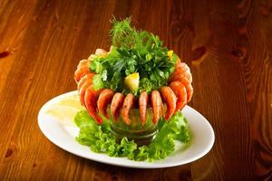 Prawn cocktail on the plate and wooden background photo