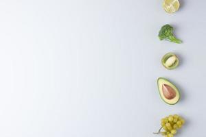 Fresh fruits and vegetables on grey background. Healthy eating concept. Flat lay, copy space. photo