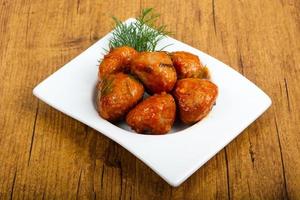 Meat balls in a bowl on wooden background