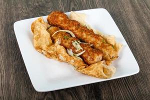 Chicken Kofta on the plate and wooden background photo