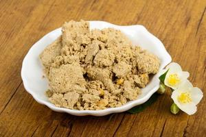 Halva in a bowl on wooden background photo