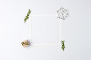 Christmas white minimal background with white frame and gift. Zero waste Christmas holiday concept. Flat lay, copy space photo