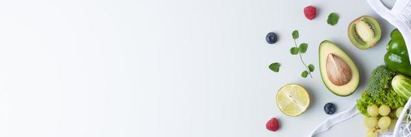 Fresh fruits and vegetables in shopper on grey background. Healthy eating and zero waste concept. Flat lay, copy space. photo