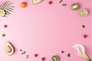 Creative tropical background made from fresh fruits and palm leaves on pink. Flat lay, copy space. photo