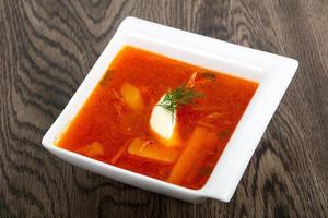 Russian Borcsh in a bowl on wooden background photo
