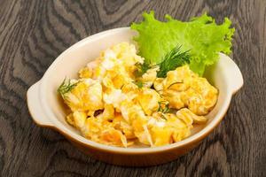 Scramble in a bowl on wooden background photo