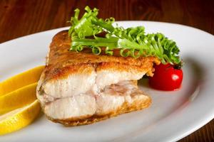 Baked salmon on the plate and wooden background photo