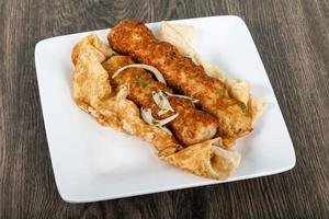 Chicken Kofta on the plate and wooden background photo