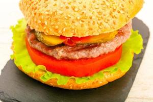 Homemade hamburger on wooden board photo