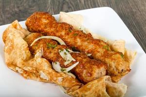 Chicken Kofta on the plate and wooden background photo