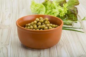 Marinated peas on wood photo