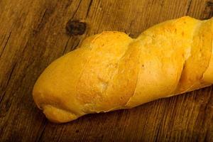 Baguette on wooden background photo