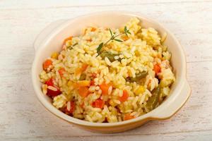 Mexican rice in a bowl on wooden background photo