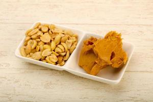 Peanut butter in a bowl on wooden background photo