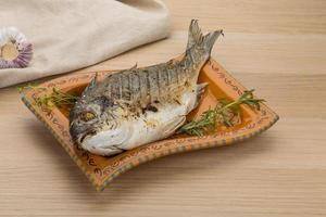 Grilled dorado on wood photo