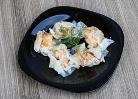 Shrimp wanton on the plate and wooden background photo