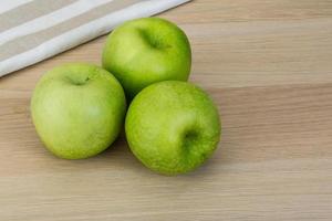 Green apple on wood photo