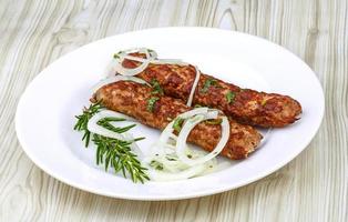 Beef kebab on the plate and wooden background photo