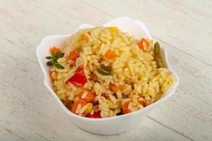 Mexican rice in a bowl on wooden background photo