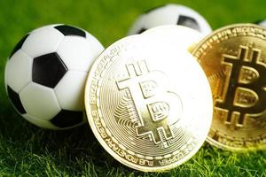 Gold bitcoin with soccer ball or football, cryptocurrency used in online sports betting.