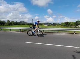 Lombok Island, Indonesia, October 8, 2022, One of the cyclists participating in the Ironman 70.3 triathlon on the island of Lombok, Indonesia photo
