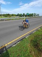 Lombok Island, Indonesia, October 8, 2022, One of the cyclists participating in the Ironman 70.3 triathlon on the island of Lombok, Indonesia photo