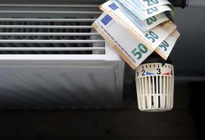 Controlling the heating costs - radiator control and Euro bills on the central heating photo