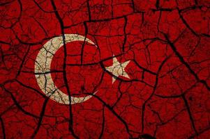 Dry soil pattern on the flag of Turkey. Country with drought concept. Water problem. Dry cracked earth country. photo
