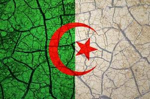 Dry soil pattern on the flag of Algeria. Country with drought concept. Water problem. Dry cracked earth country. photo