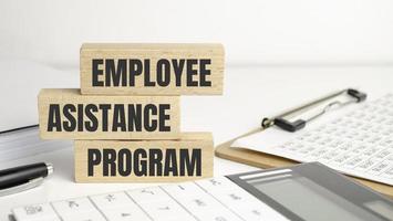 EAP Employee Assistance Program on wooden block and office desk photo