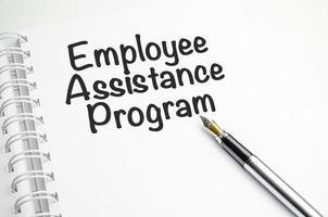 EAP Employee Assistance Program - word on a white notebook against the background photo