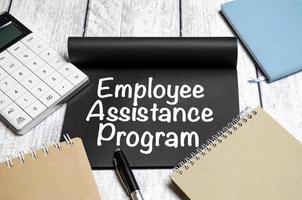 word EAP Employee Assistance Program text on white paper on wooden background photo