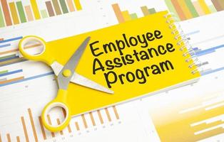 EAP Employee Assistance Program on yellow notebook and charts photo